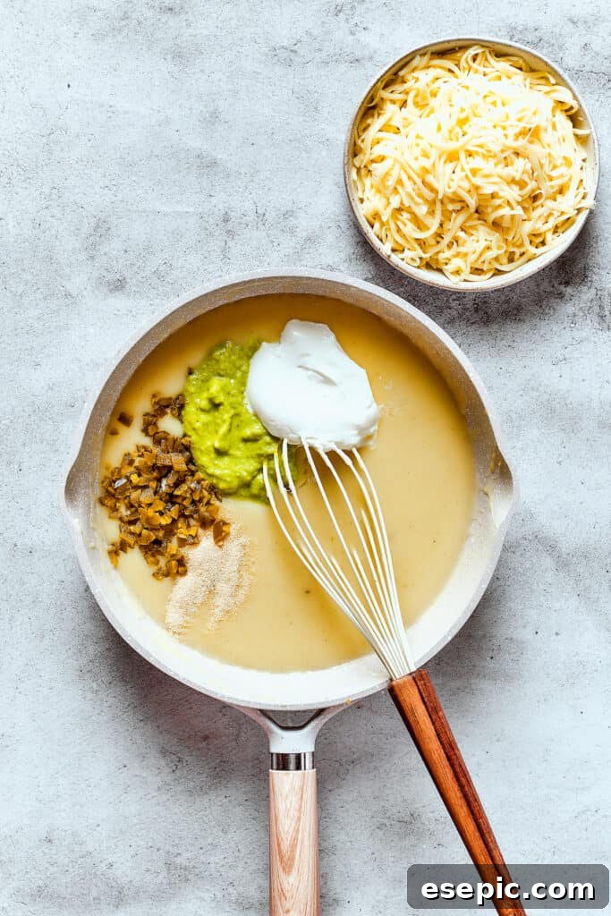 Making a creamy green enchilada sauce in a skillet.