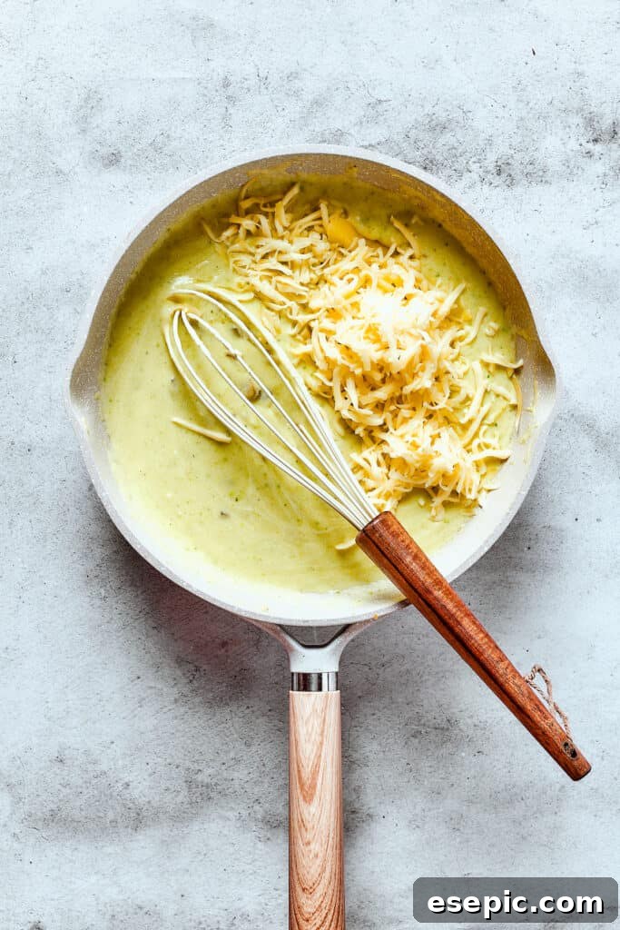 Whisking cheese into enchilada sauce.