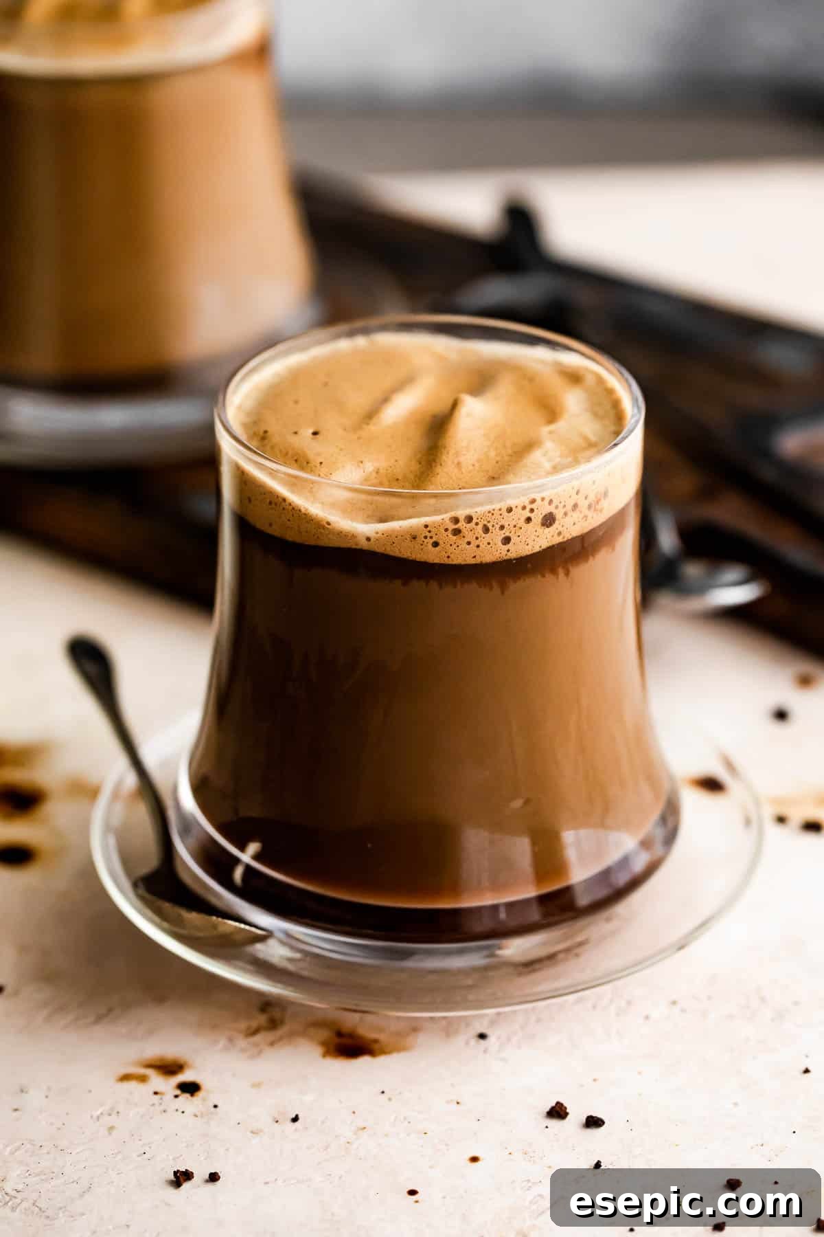 Homemade Macchiato served in a glass mug.