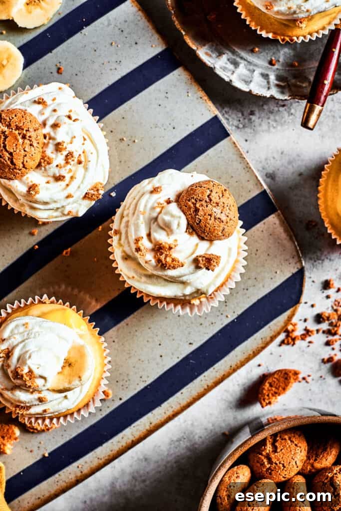Decadent Banana Pudding Cupcakes 16 An overhead shot of elegantly frosted banana pudding cupcakes arranged on a decorative silver platter, showcasing their beautiful presentation.