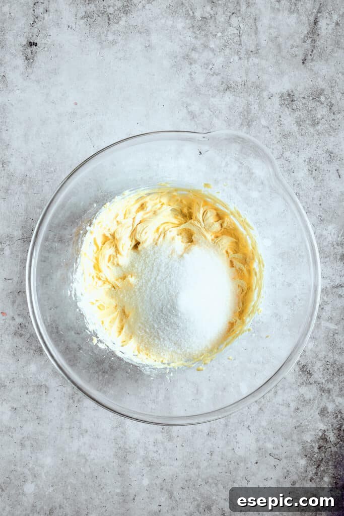 Decadent Banana Pudding Cupcakes 5 Close-up shot of unsalted butter and granulated sugar being creamed together in a mixing bowl until light and fluffy.