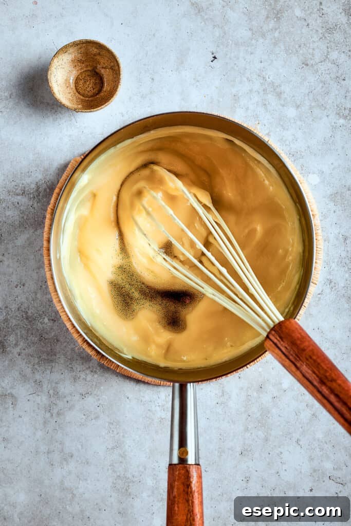 Decadent Banana Pudding Cupcakes 10 The rich, creamy banana pudding mixture after it has thickened on the stovetop, showcasing its smooth consistency in a saucepan.