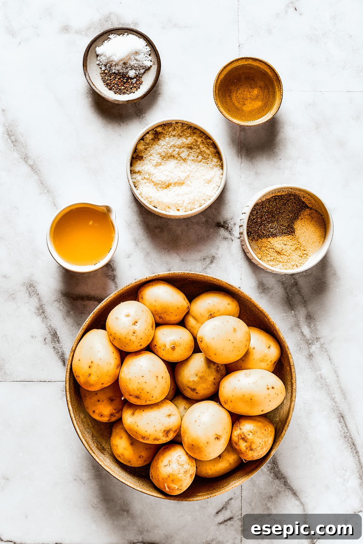 Ingredients for roasted parmesan crusted potatoes, meticulously arranged on a work surface.