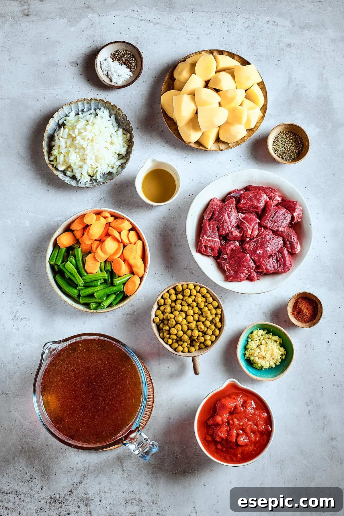Mulligan Stew Ingredients Laid Out Fresh ingredients for Mulligan stew artfully arranged on a rustic wooden table.