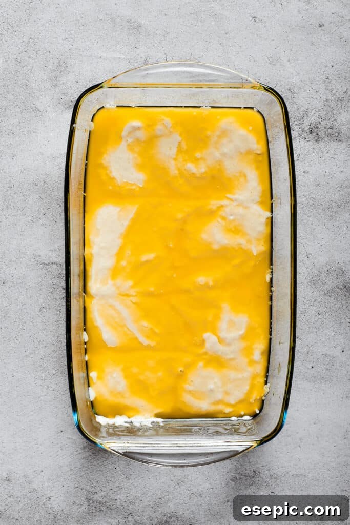 Biscuit dough in a baking dish full of melted butter, demonstrating the 'swim' technique.
