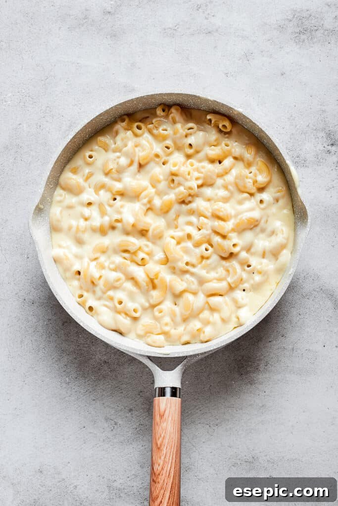 A sauce pan full of mac and cheese.