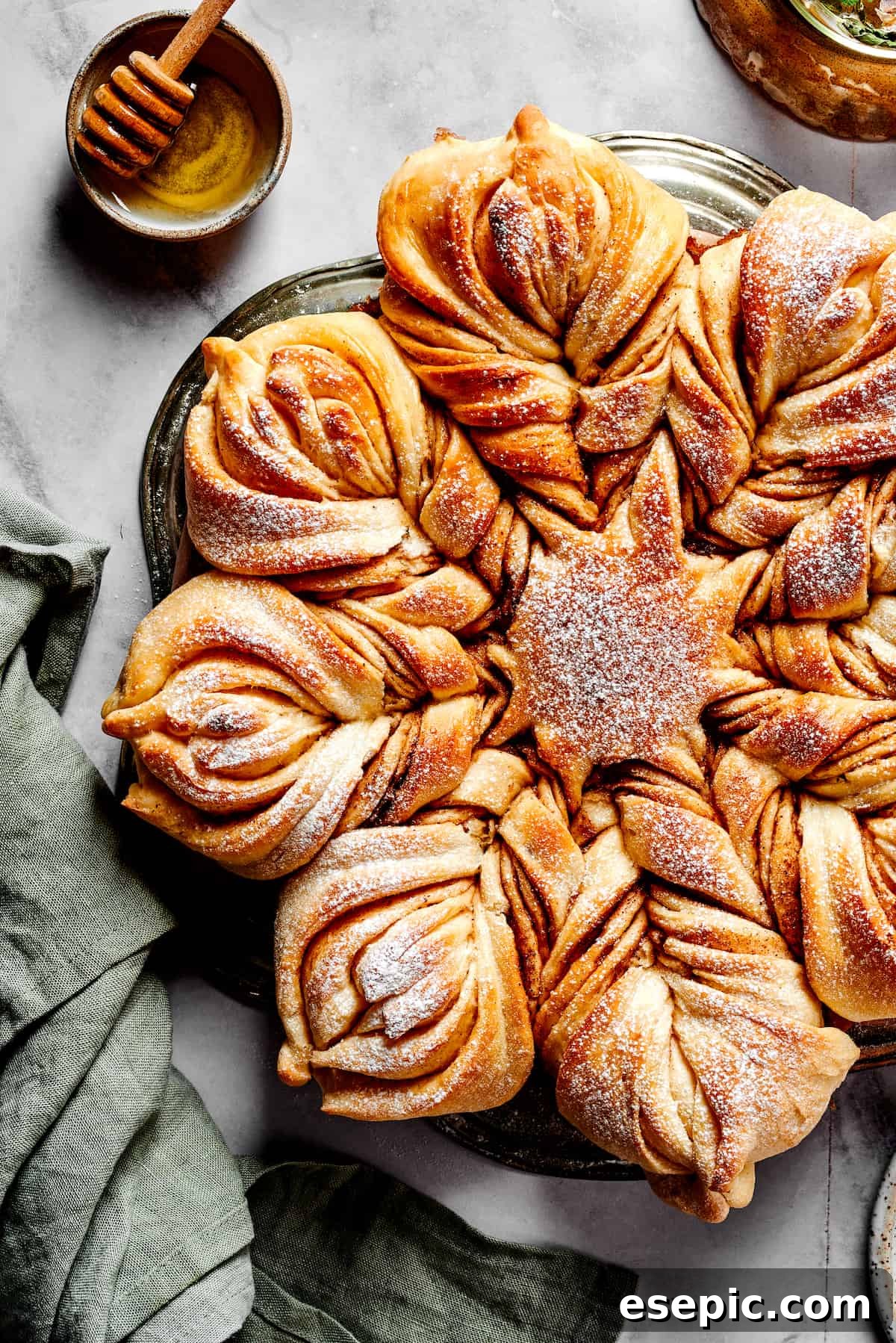 Aerial view of pull-apart star bread topped with powdered sugar.