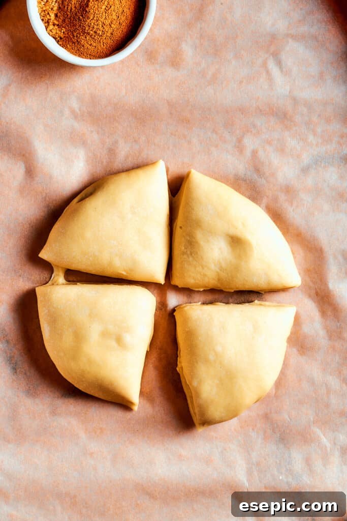 Overhead view of dough cut into 4 segments.
