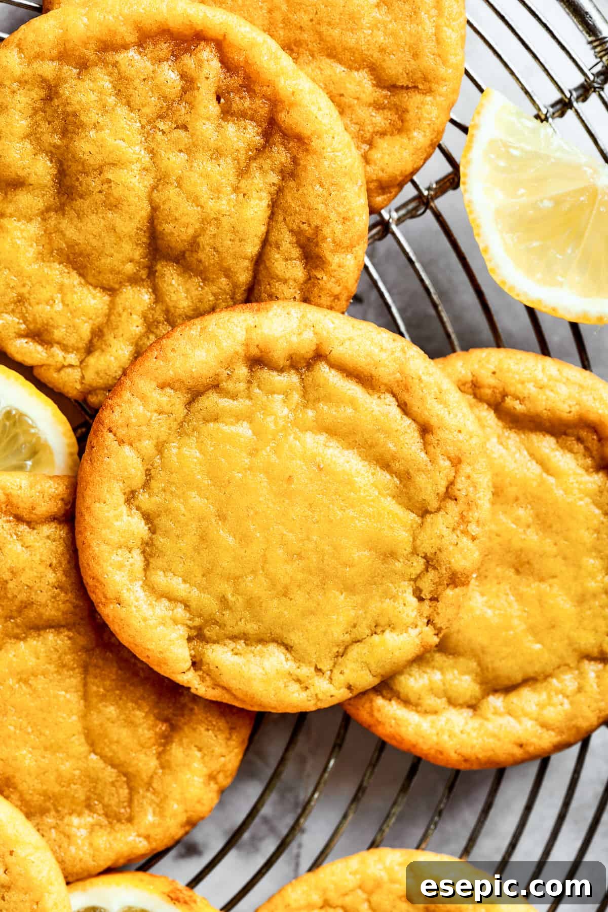 Close-up shot of several lemon cookies arranged on a round wire rack.