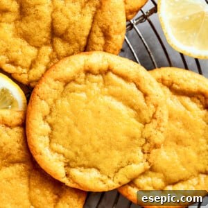 Close-up shot of several lemon cookies arranged on a round wire rack.