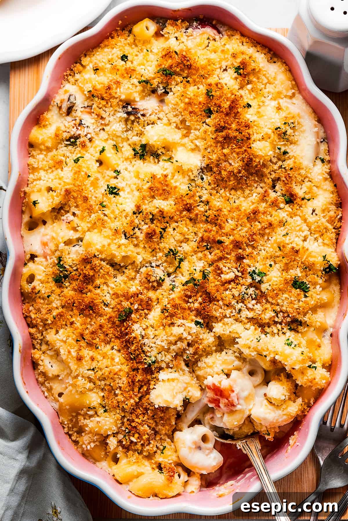 Cooked Seafood mac and cheese with a serving spoon ready to take some out.