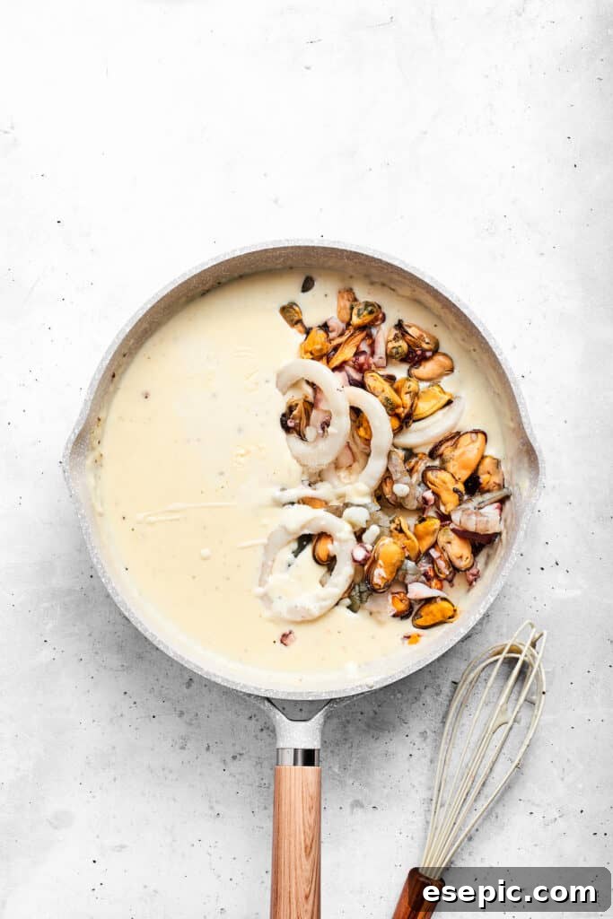 Adding seafood to the sauce.