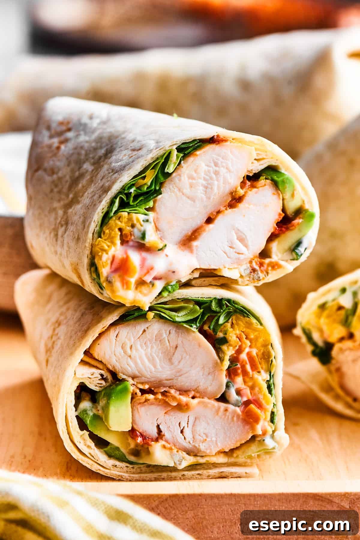 A beautifully cut Buffalo Chicken Wrap showcasing its delicious interior of chicken, cheese, and fresh vegetables.