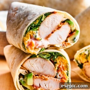 A cut buffalo chicken wrap shows the interior of chicken and vegetables.