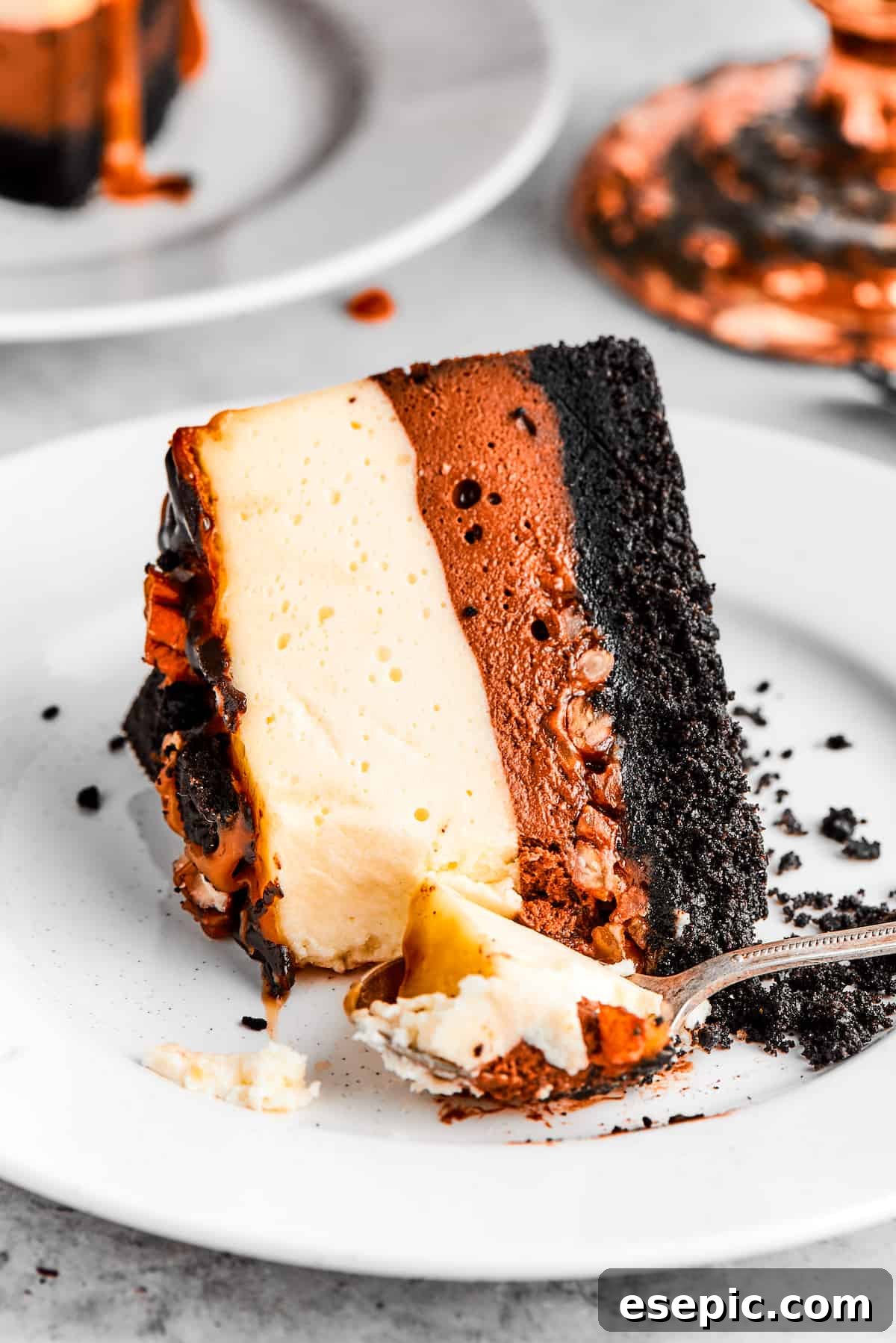 A slice of turtle cheesecake served on a dessert plate.