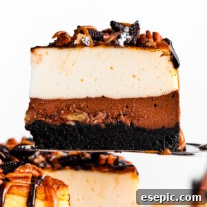 A cake server holding up a slice of turtle cheesecake.
