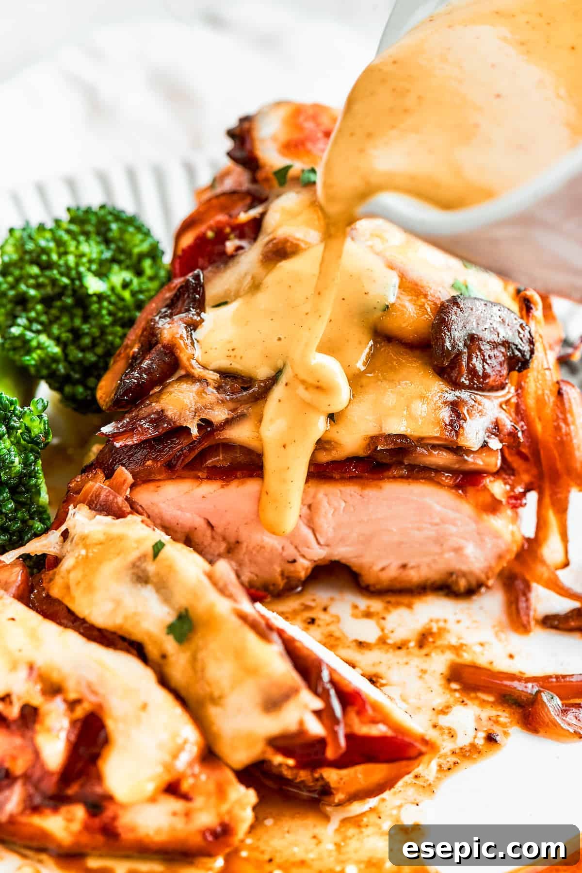A thick stream of vivid yellow honey mustard sauce is added to a plate of Alice Springs chicken.
