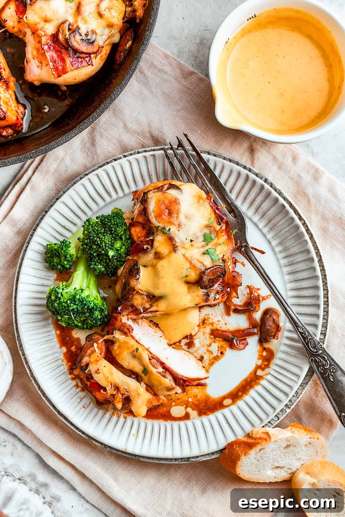 Portions of Alice Springs chicken are shown on plates with a skillet of chicken to the left and a bright pitched of yellow honey mustard sauce.