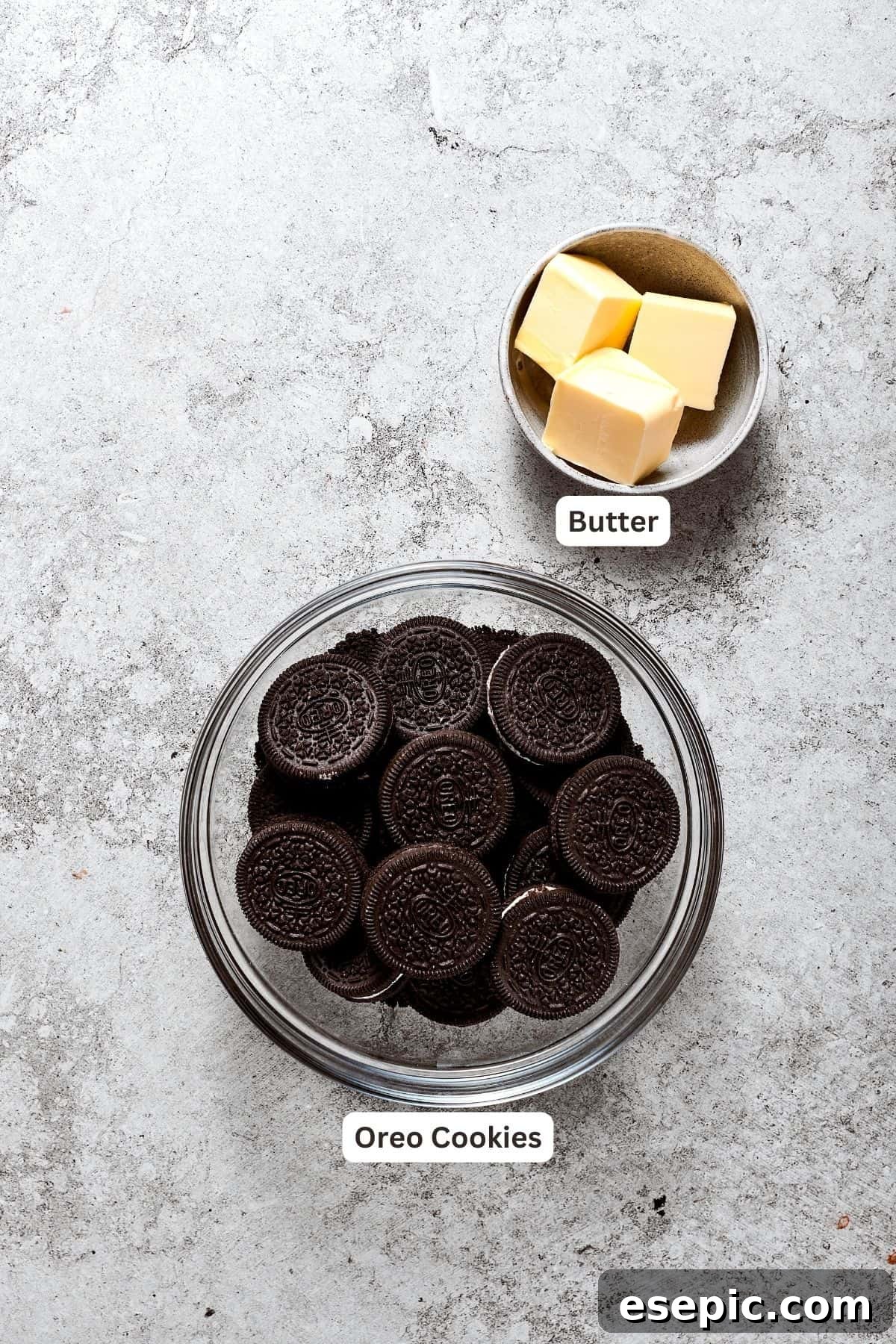 All you need for the perfect Oreo cookie crust. Ingredients laid out for the Oreo crust: a stack of Oreo cookies and cubes of unsalted butter.