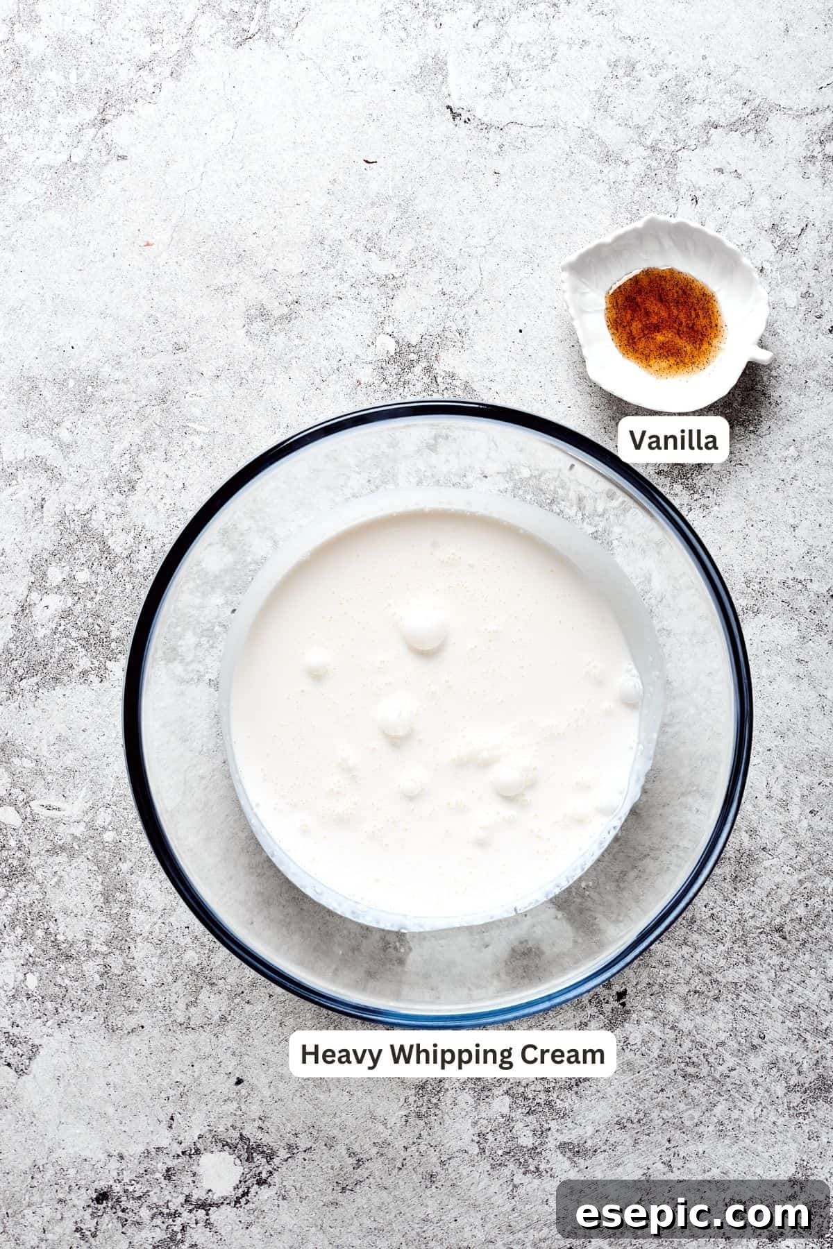 The finishing touch: ingredients for a light and airy whipped cream. Ingredients for the whipped cream topping: chilled heavy cream and vanilla bean paste, plus chocolate for garnish.
