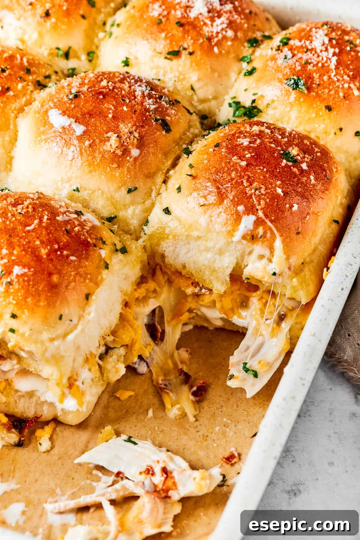 Toasted chicken bacon ranch sliders in a baking pan, golden brown and cheesy.
