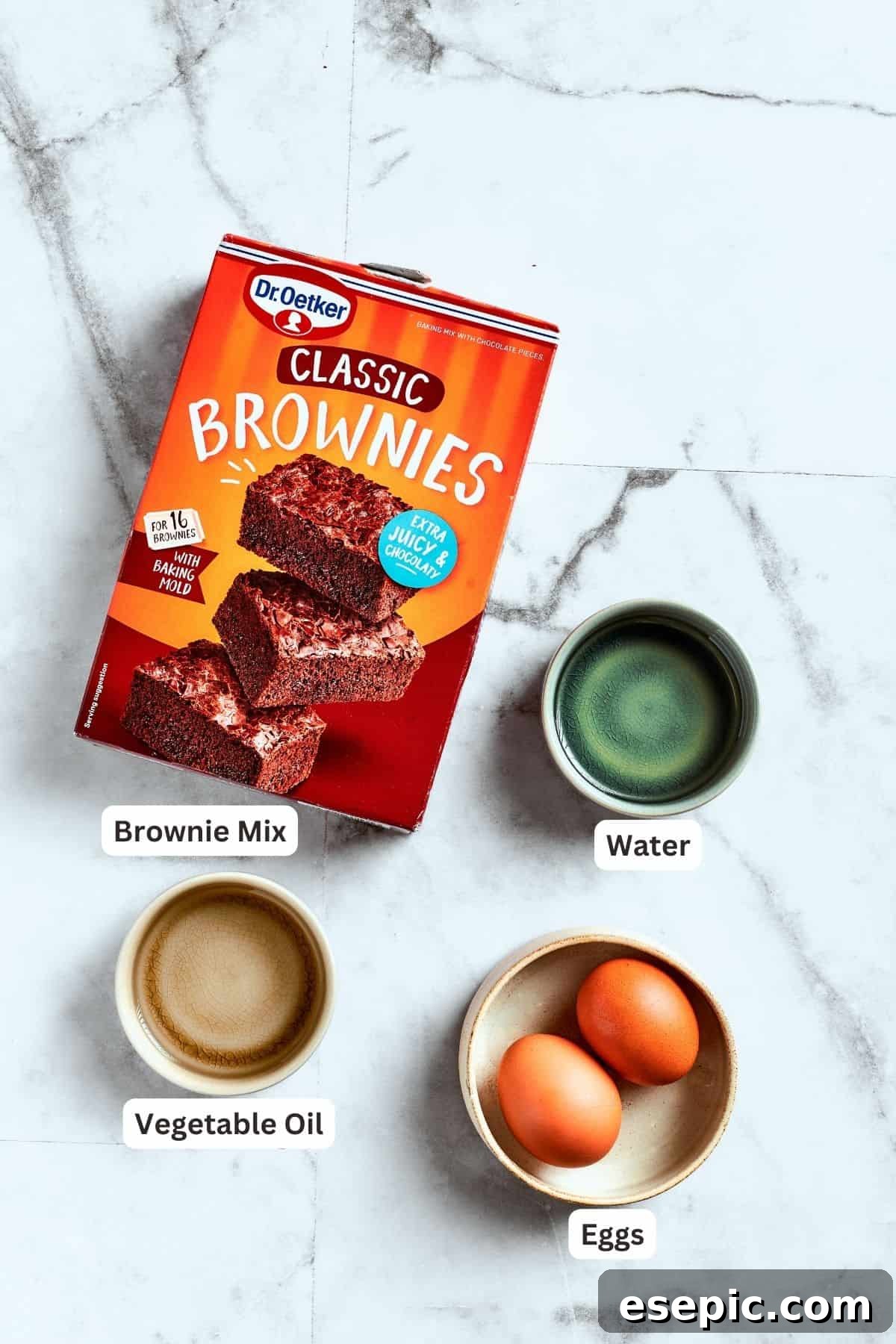 Brownie base ingredients laid out. The ingredients for pecan pie brownies are shown: brownie mix, eggs, water, oil.