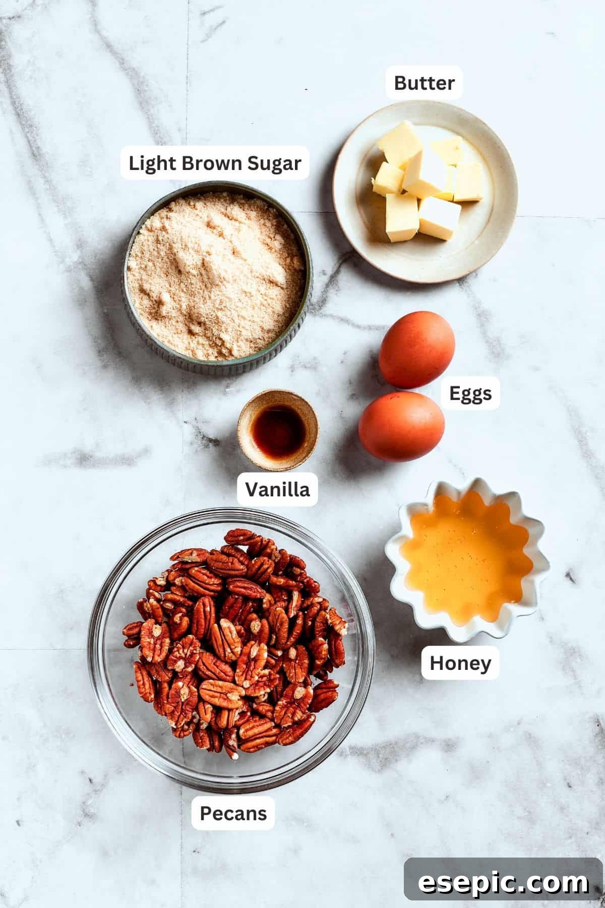 Gooey Pecan Pie Brownie Bars 2 The filling ingredients for pecan pie brownies are shown: pecans, vanilla, eggs, honey, brown sugar.
