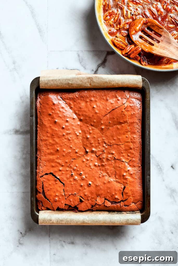 Freshly baked brownies, ready for the topping. The baked brownies are shown in the pan.