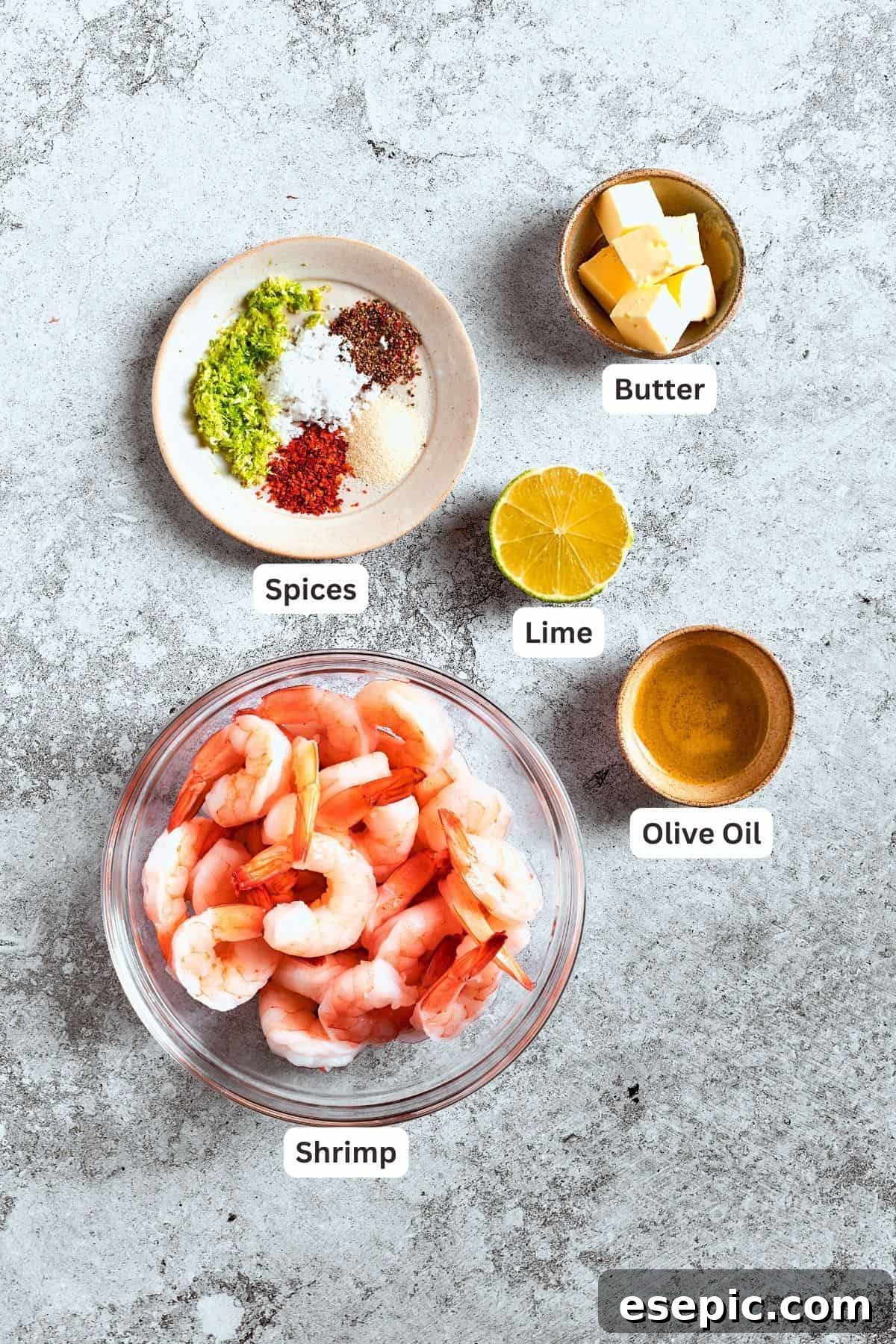 The ingredients for the shrimp are shown: shrimp, spices, butter, lime, olive oil.