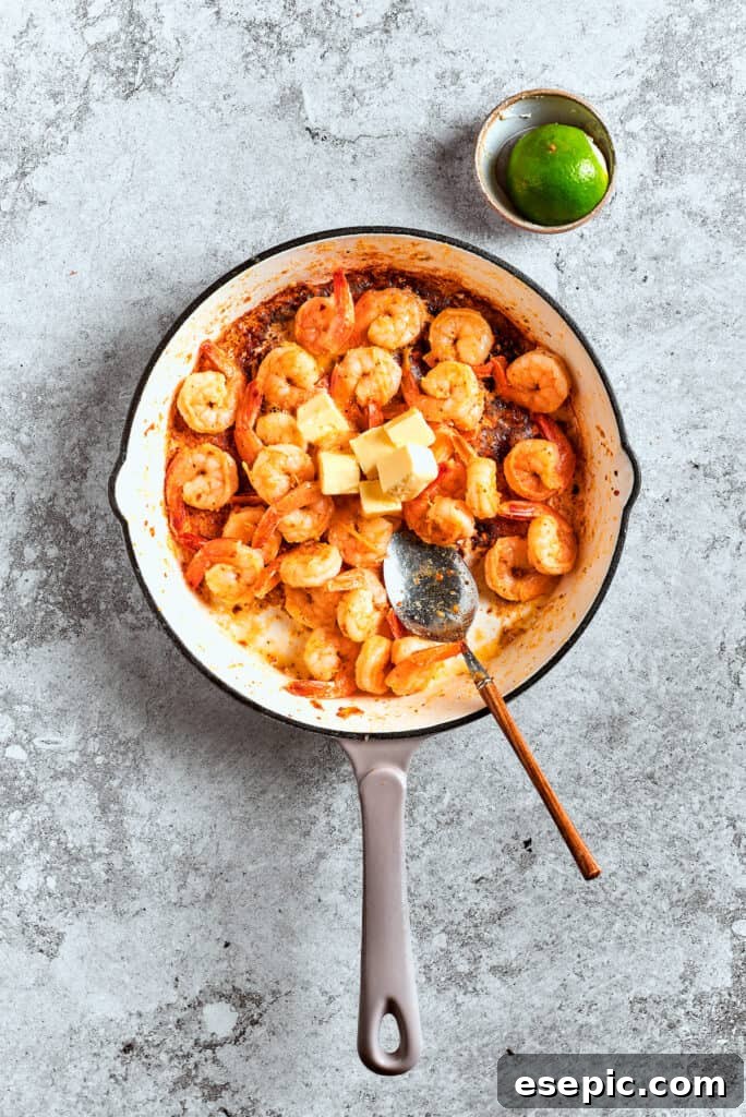 Shrimp is sauteed in a pot.