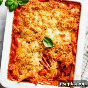 A beautifully baked Chicken Parmesan Casserole, golden and bubbly, garnished with fresh basil leaves, straight out of the oven, perfect for serving.
