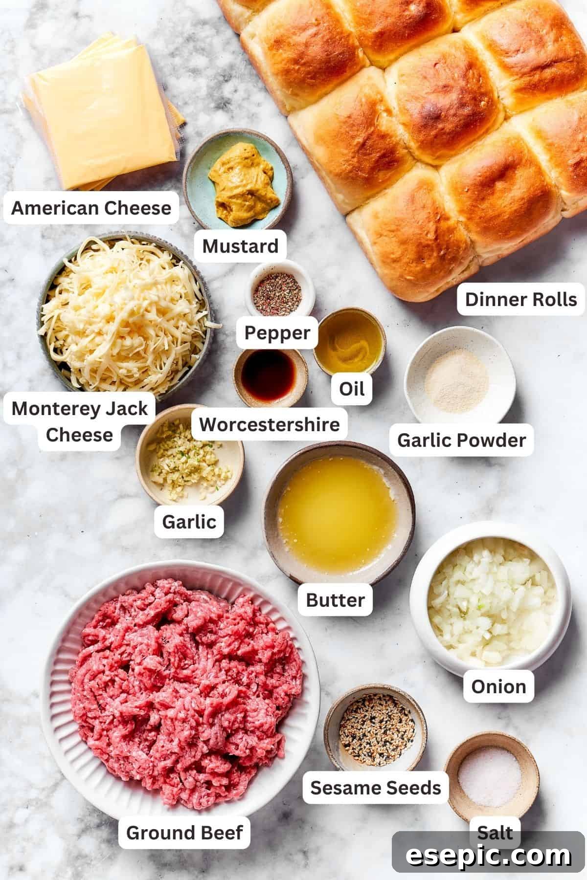 The ingredients for cheeseburger sliders are shown portioned out and labeled, including rolls, beef, American cheese, Jack cheese, Worcestershire sauce, garlic powder, oil, butter, onion, garlic, mustard, salt and pepper.