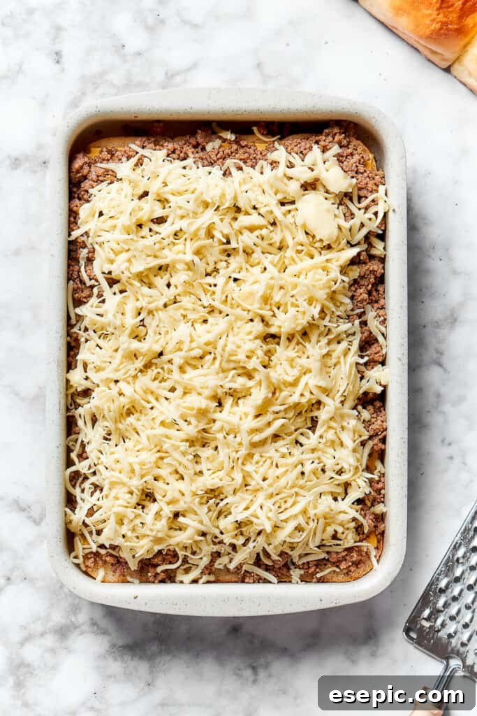 A generous sprinkling of shredded Monterey Jack cheese covers the ground beef, promising a gooey, melted topping.
