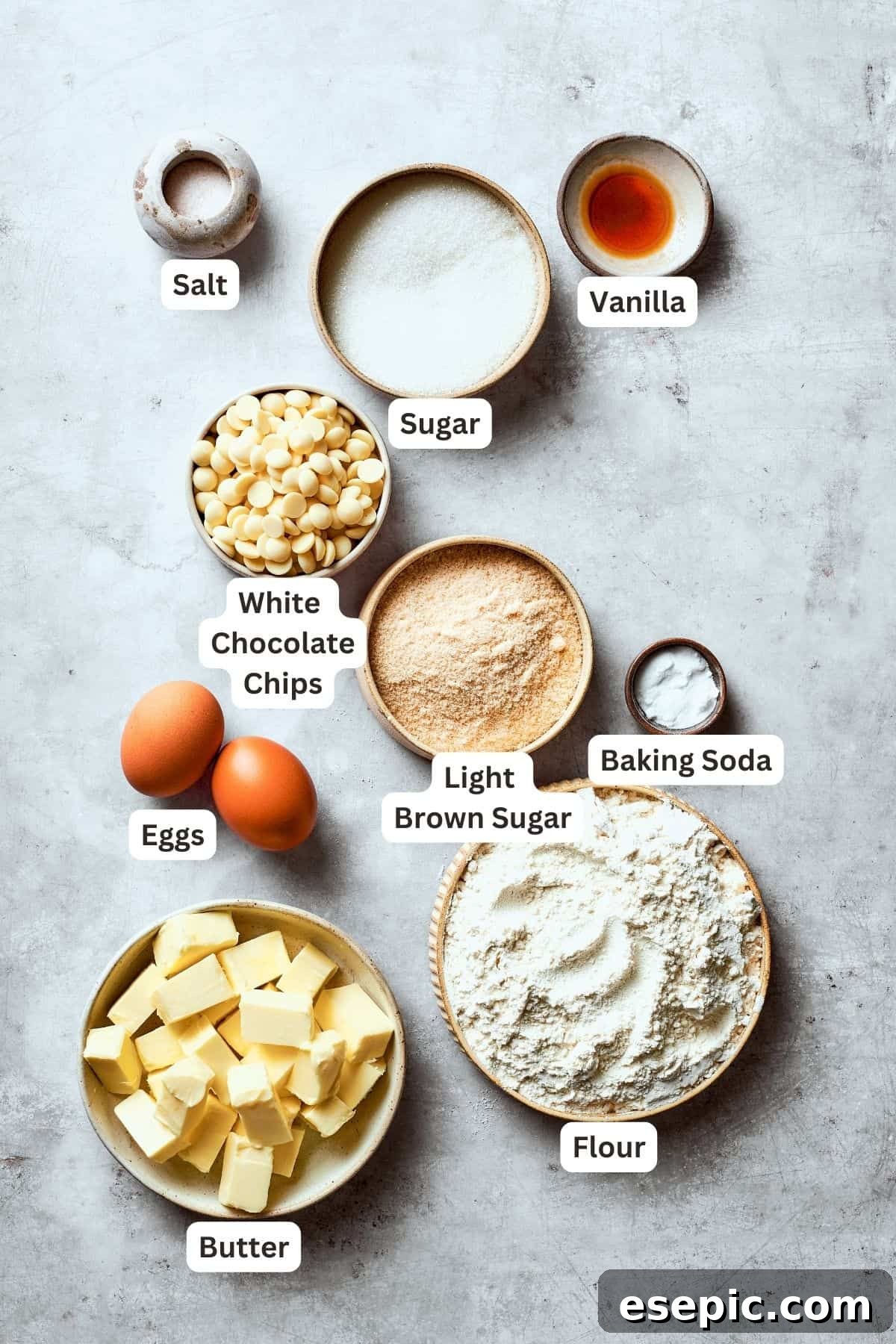 Gather your ingredients for chewy, buttery White Chocolate Chip Cookies, packed with creamy, sweet white chocolate chips for an unexpected twist. All the essential ingredients for making delicious white chocolate chip cookies are neatly arranged and labelled: white chocolate chips, flour, butter, granulated sugar, brown sugar, baking soda, eggs, vanilla extract, and salt.