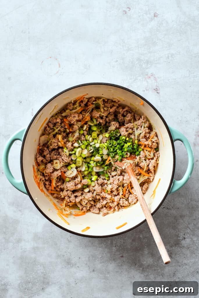 The green onion is stirred int the filling.