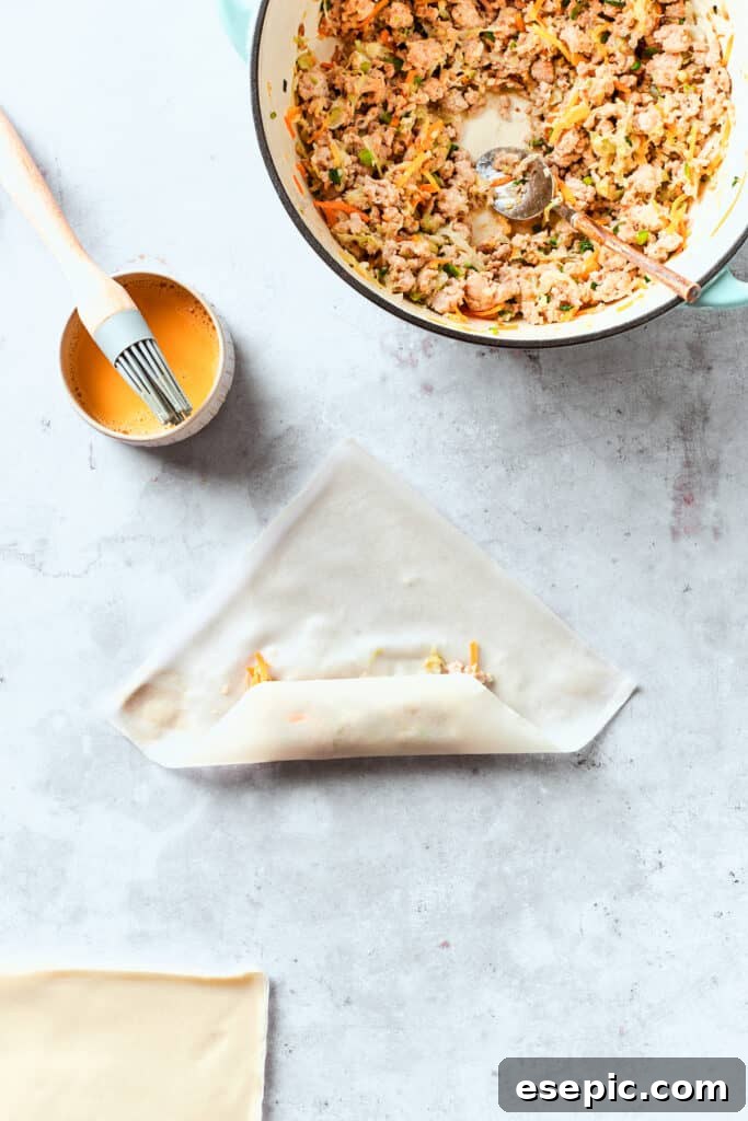 The egg roll wrapper is folded around the filling.