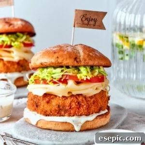 Sauce is seen dripping from a shrimp burger.