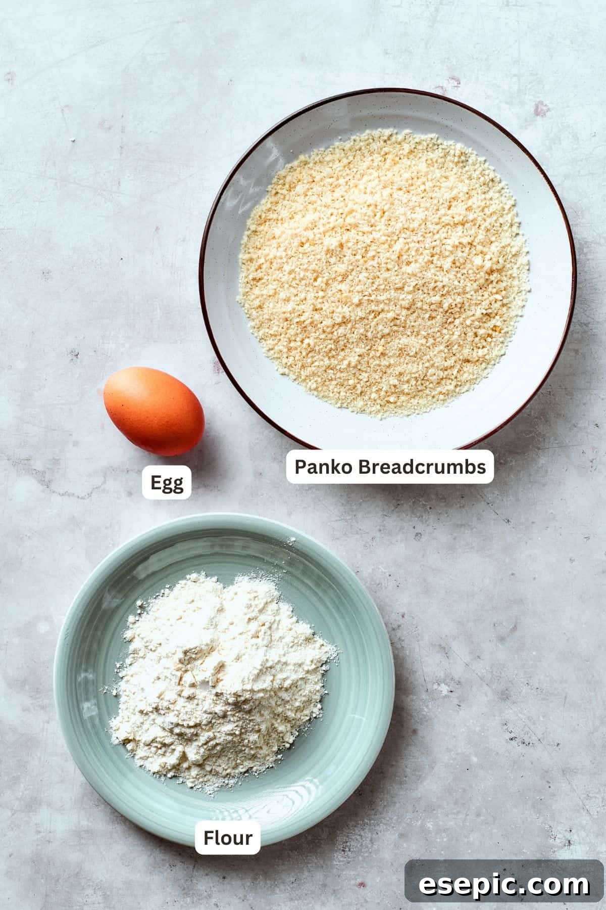 The breading ingredients, panko bread crumbs, flour, and egg, are portioned out and labelled for easy assembly of shrimp burgers.