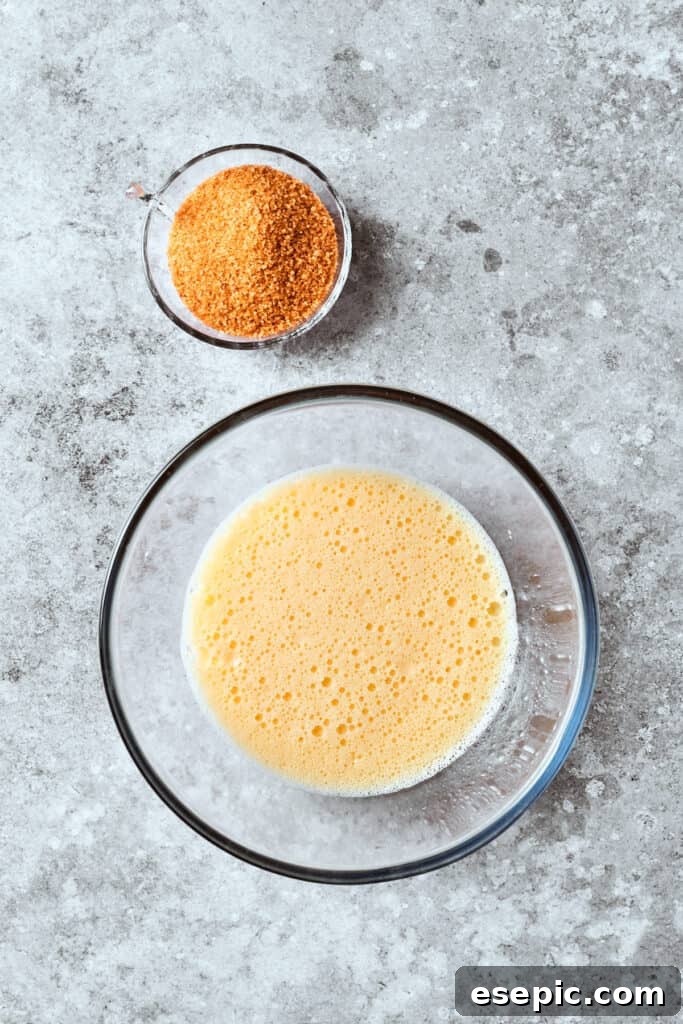 Butter and sour cream are mixed in a bowl, forming a smooth, creamy base for the batter.