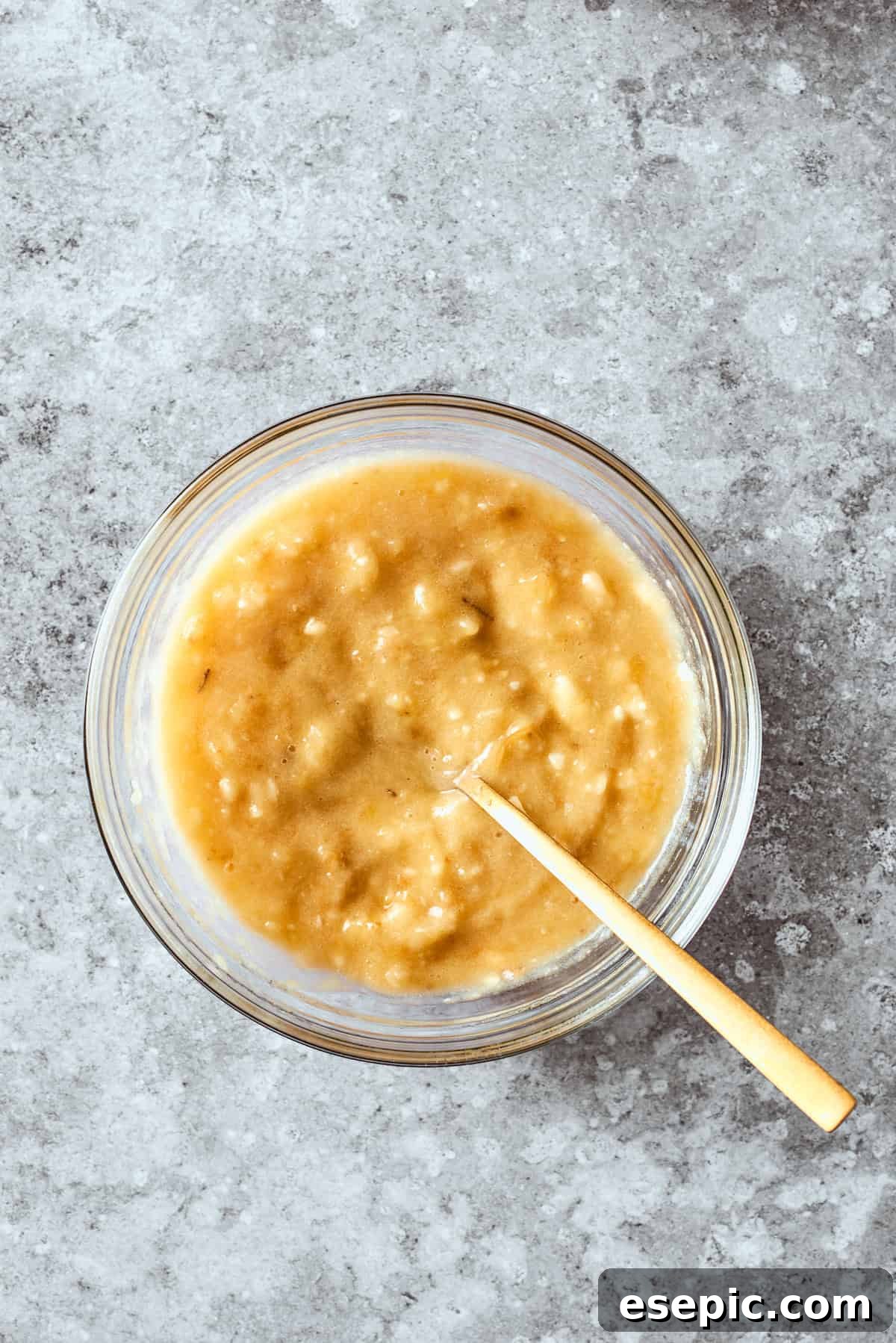 The mashed bananas are gently folded into the wet mixture, ensuring even distribution of flavor.