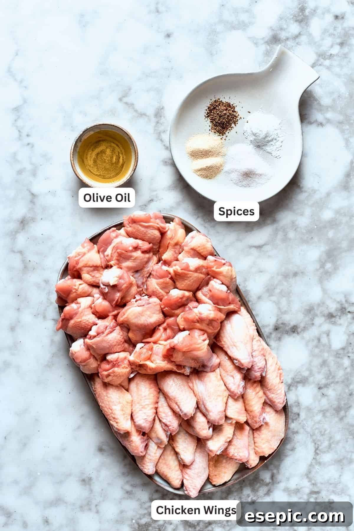 Ingredients for buffalo wings are labeled and portioned: chicken, olive oil, spices, baking powder.