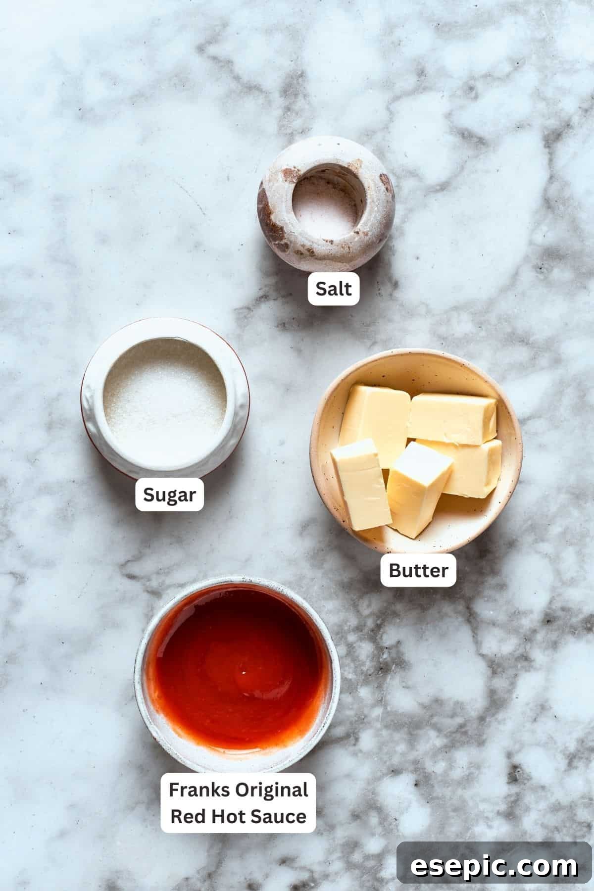 Ingredients for buffalo wings sauce are labeled and portioned: butter, sugar, salt, hot sauce.
