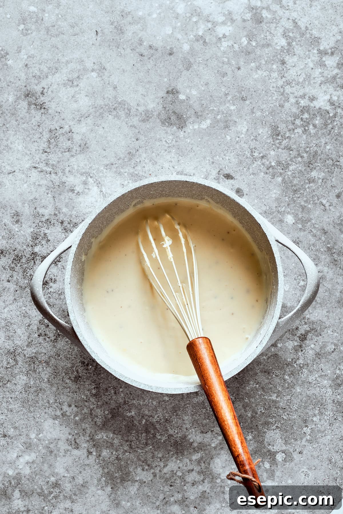 Golden Fried Country Steak 13 A whisk blends the sauce in a bowl.