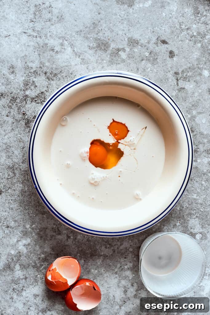 Golden Fried Country Steak 7 Egg is mixed into a bowl of milk.