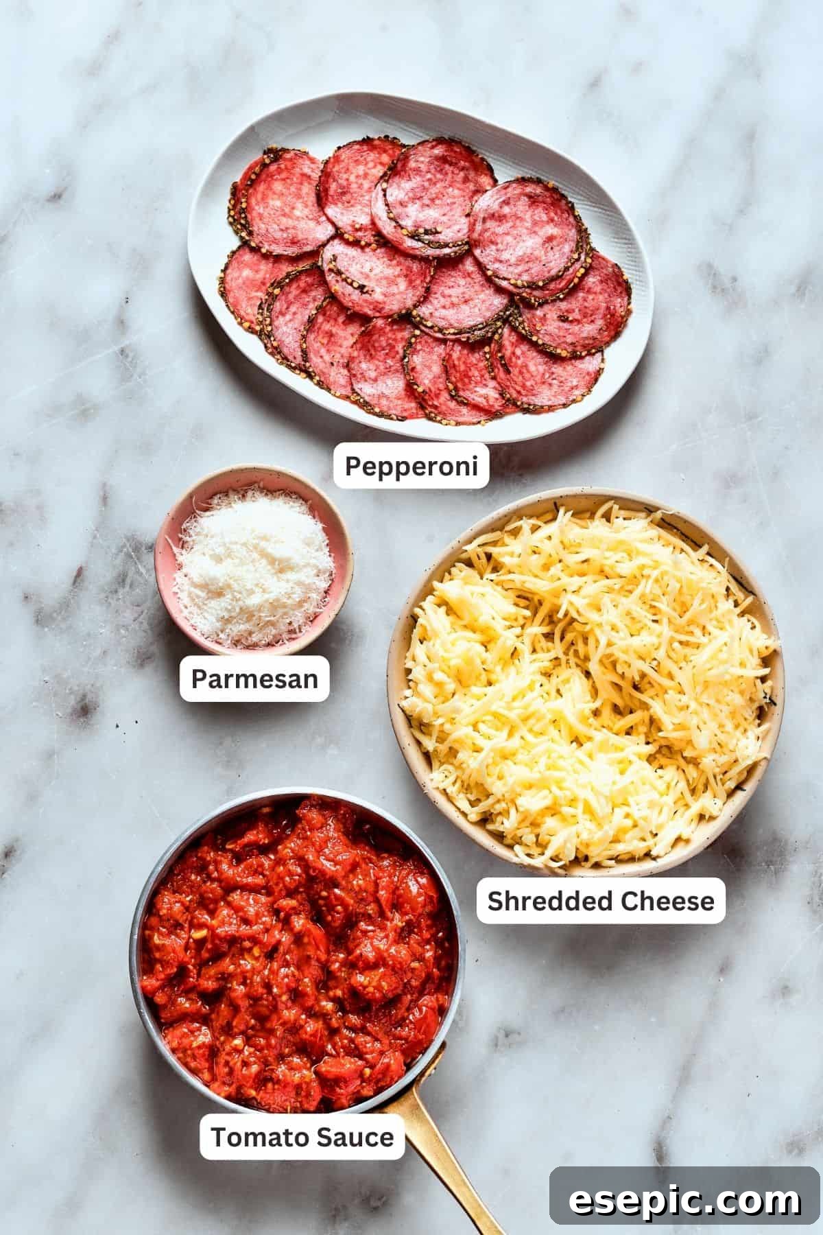 Deep dish pizza toppings: shredded mozzarella, shredded Edam, grated parmesan, pepperoni slices, fresh basil.