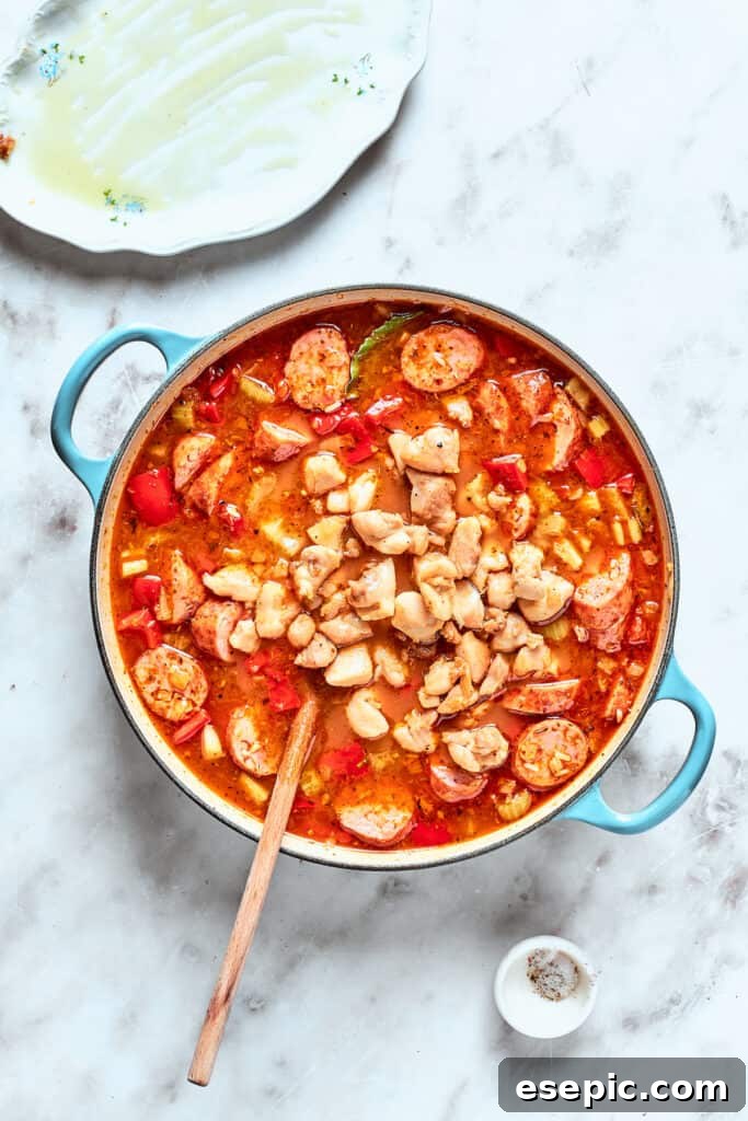 Chicken is stirred back into the jambalaya.