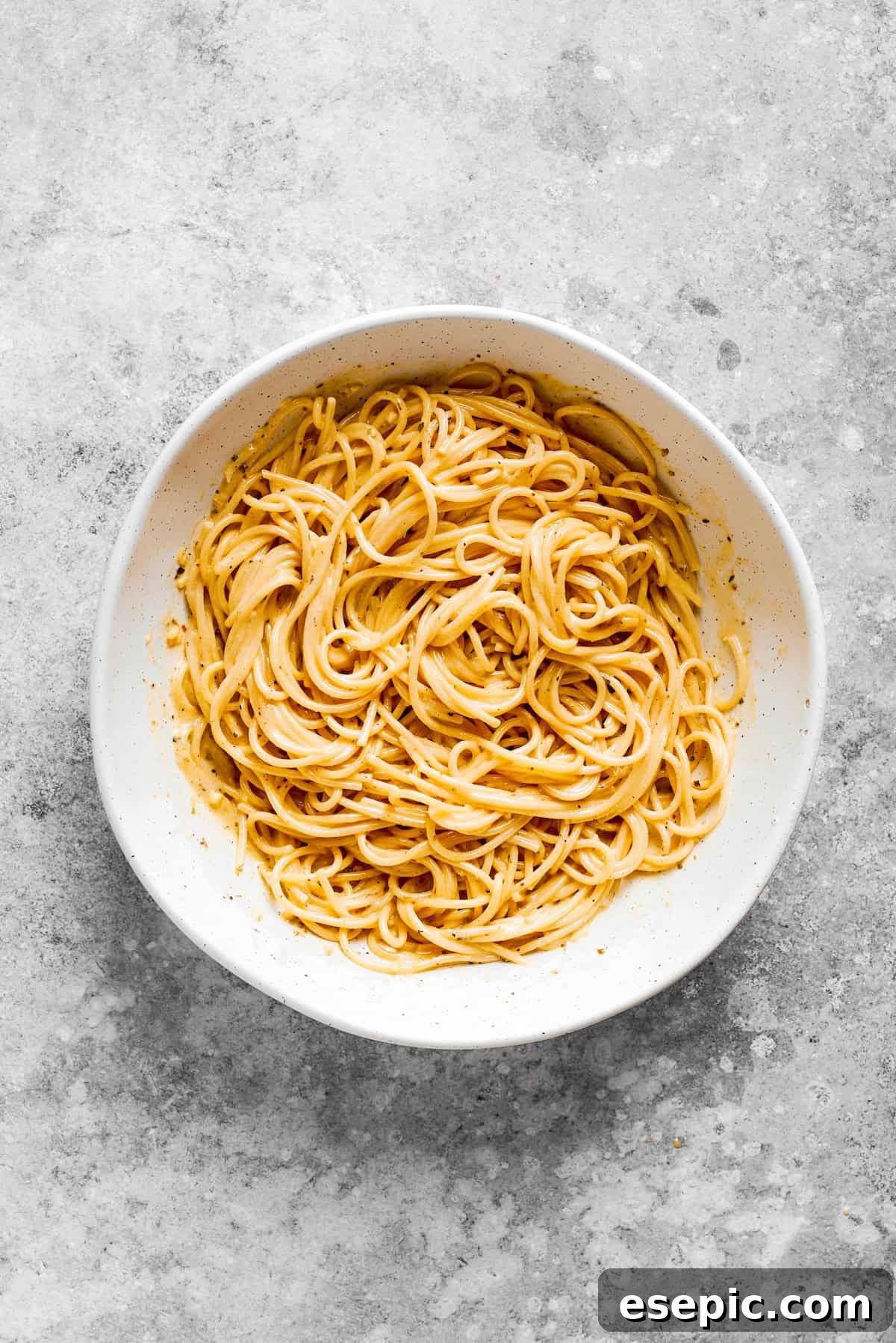A bowl filled with cooked spaghetti noodles, illustrating the perfect al dente texture for a cold pasta salad.