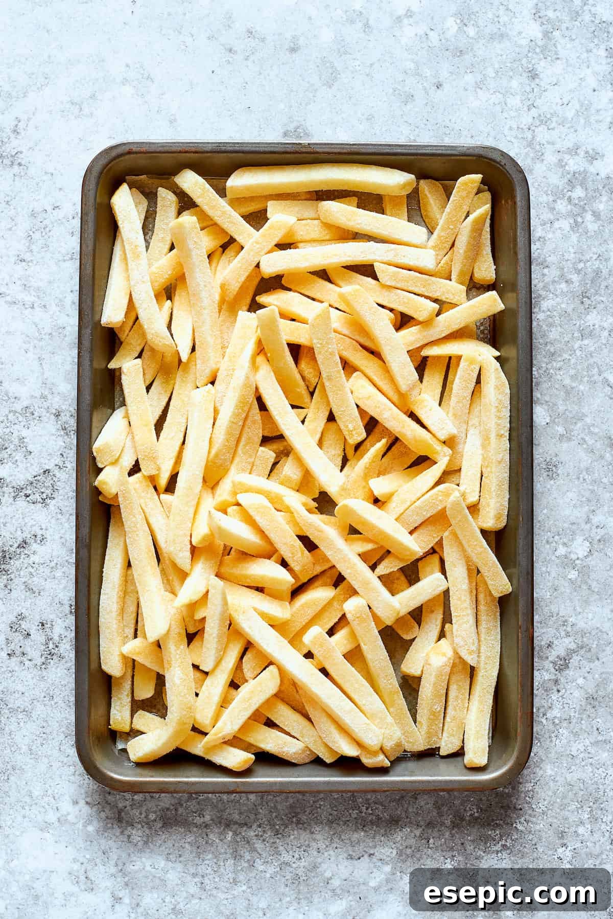 Pizza Fry Fusion 5 French fries are cooked on a baking sheet.