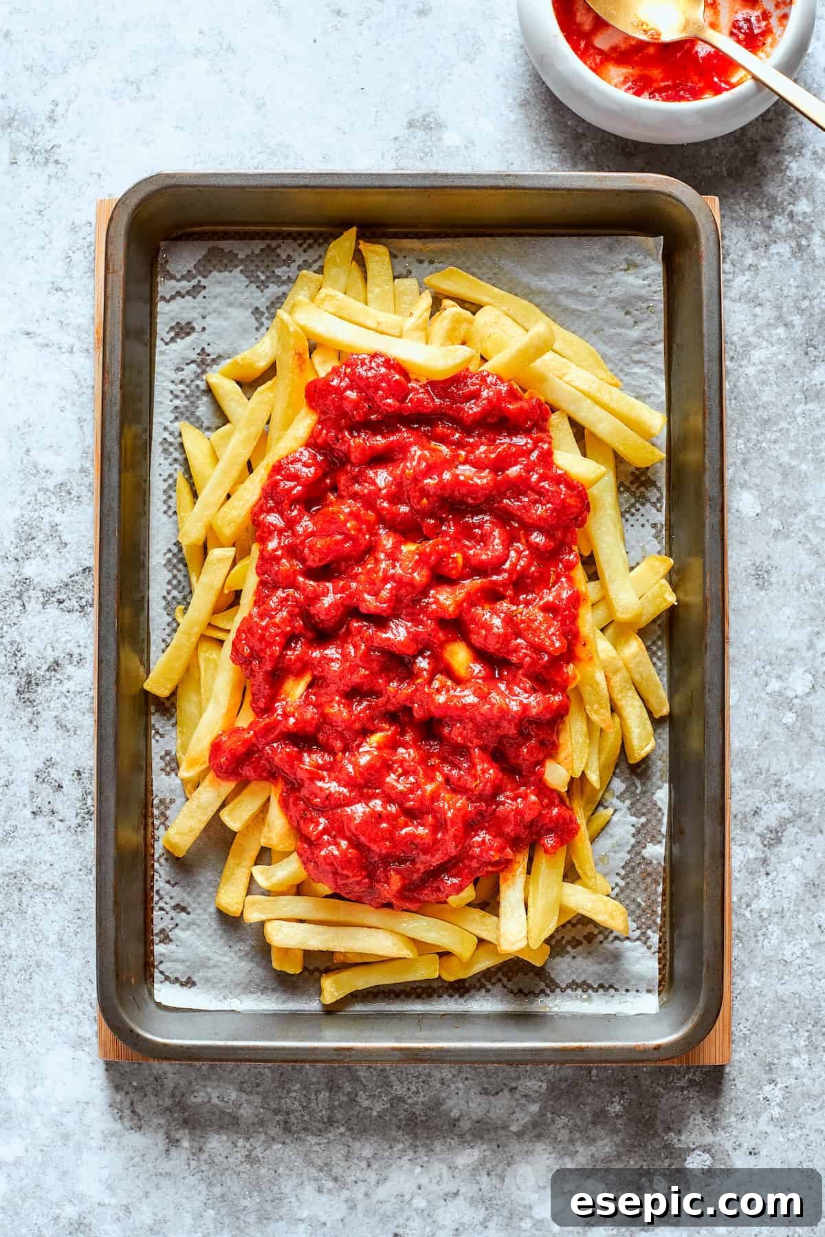 Pizza Fry Fusion 6 Sauce is added to the cooked fries,