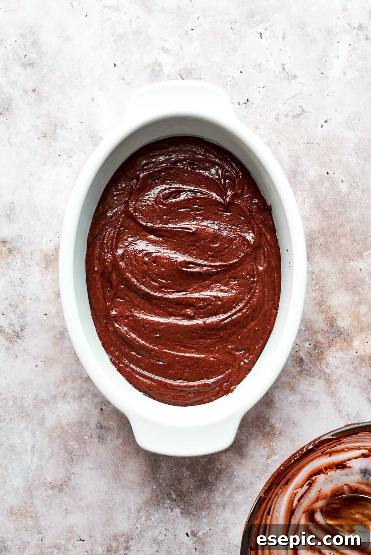 This moist and gooey Chocolate Pudding Cake is loaded with rich chocolate flavor in every bite. Best served warm! Chocolate pudding cake in an oval pan.